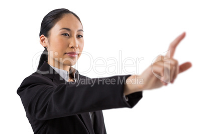Businesswoman pressing an invisible virtual screen