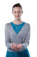 Teenage girl pretending to hold invisible object