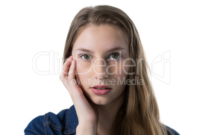 Confused teenage girl with hand on face
