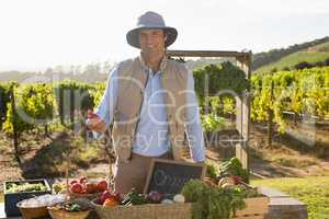 Portrait of happy man standing at vegetable stall