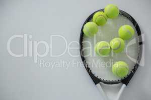 Overhead view of tennis balls on racket