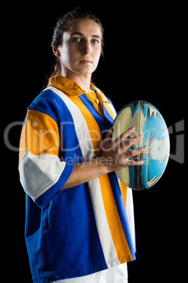 Portrait of confident player with rugby ball