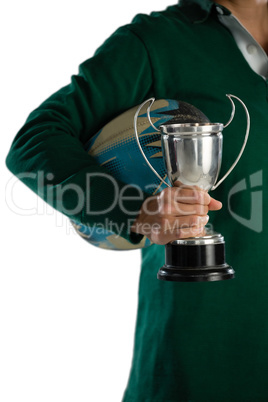 Cropped image of female rugby player with trophy and ball