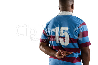 Rear view of male rugby player with fingers crossed