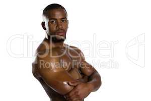 Portrait of shirtless sportsman with arms crossed