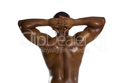 Rear view of shirtless sportsman with hands behind head