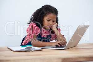 Girl as business executive using laptop