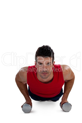 Portrait of determined sportsperson exercising with dumbbells