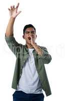 Man shouting and gesturing against white background