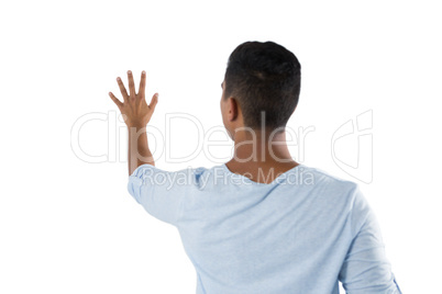 Man pretending to touch an invisible screen against white background