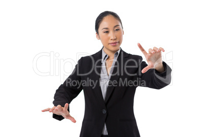 Businesswoman pressing an invisible virtual screen