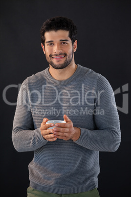 Portrait of smiling man holing a cup of tea