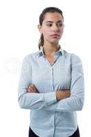 Female executive standing with arms crossed against white background