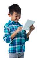 Boy using digital tablet against white background