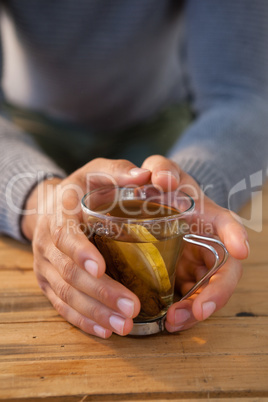 Man holding a cup of lemon tea