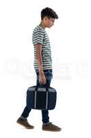 Teenage boy walking with bag