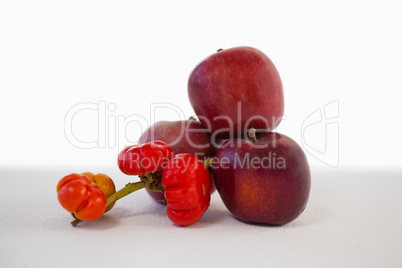 Close-up of red apples and surinam cherry