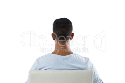 Rear view of man sitting on chair