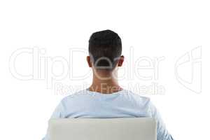 Rear view of man sitting on chair