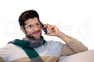 Man talking on mobile phone against white background