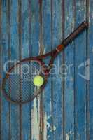 Overhead view of brown tennis racket with ball