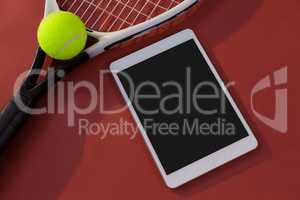 High angle view of tennis racket and ball by digital tablet