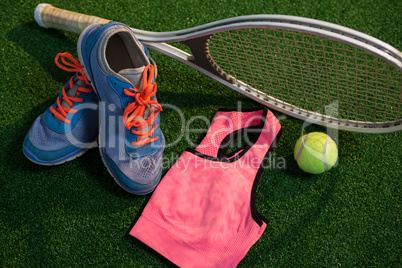 Sports shoes with tennis ball and racket by sports bra