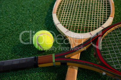 Close up of wooden racket with tennis ball