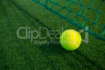 Close up of tennis ball by net