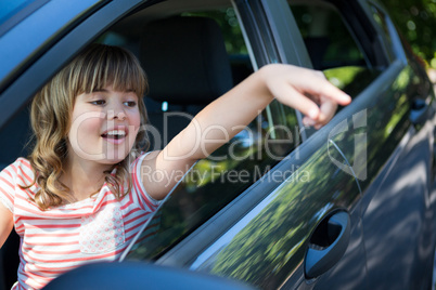 Teenage girl sitting in the back seat of car