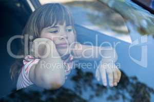 Teenage girl sitting in the car