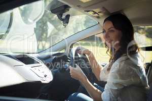 Smiling woman driving a car