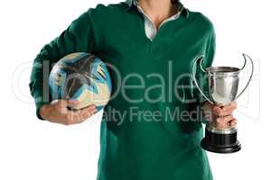 Mid section of woman holding trophy and rugby ball
