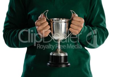 Mid section of female rugby player holding trophy