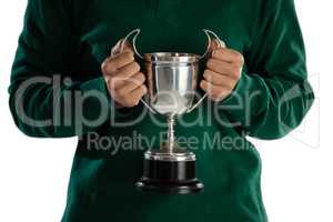 Mid section of female rugby player holding trophy