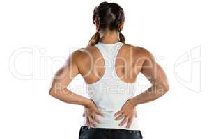 Rear view of female athlete suffering from back pain