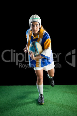 Portrait of female athlete wearing helmet while playing rugby