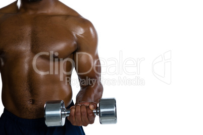Mid section of muscular sportsman exercising with dumbbells