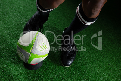 High angle view man kicking rugby ball