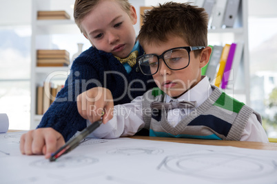 Kids as business executives drawing graphs