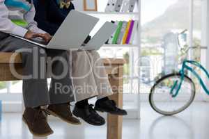 Kids as business executives using laptop in office