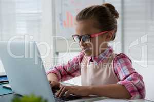 Girl as business executive using laptop while sitting