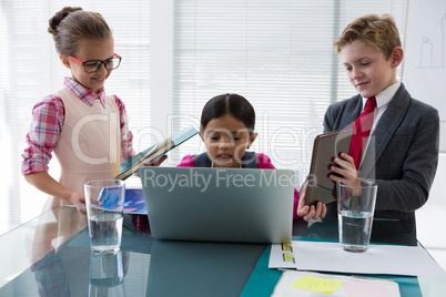 Kids as business executives interacting while meeting