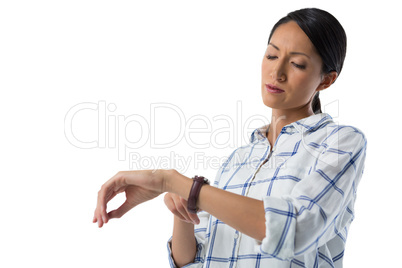 Female executive looking at her wristwatch