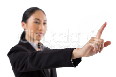 Businesswoman pressing an invisible virtual screen