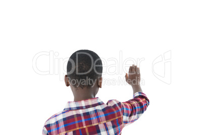 Boy pretending to touch an invisible screen against white background