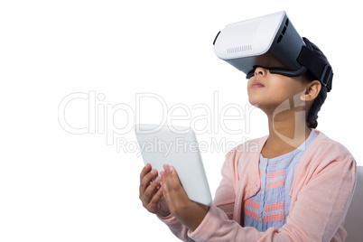 Girl holding digital tablet while using virtual reality glasses