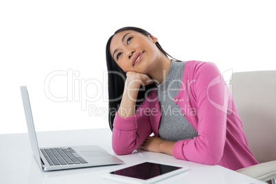 Female executive with laptop against white background