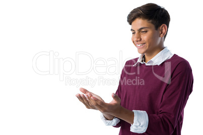 Teenage boy pretending to hold an invisible object