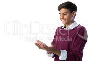 Teenage boy pretending to hold an invisible object